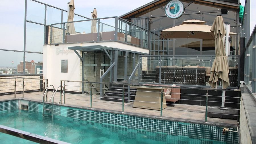 Lounge area with a swimming pool in the front at BluSalzz Residence, Amritsar.